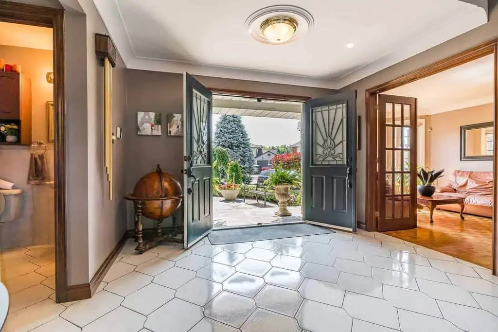 The entrance to a Hamilton property with tiled floors and a door.