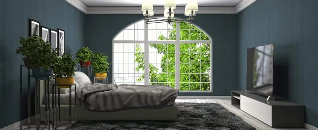 an eco friendly property bedroom with blue walls and a large window.