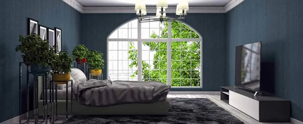 Modern bedroom with a large window overlooking greenery, featuring a floating bed, dark walls, and minimalistic decor incorporating sustainability practices in property management.