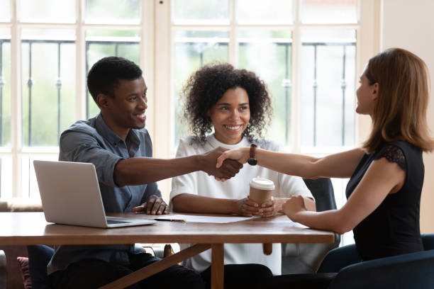 A group of people **engaging in a** Tenant Experience at a table, property services company