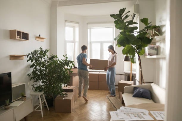 Two people moving into a new apartment managed by Hamilton property management services - moving stock photos & royalty-free footage.