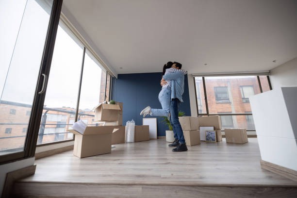 A man and woman demonstrating tenant retention by hugging in their new home.