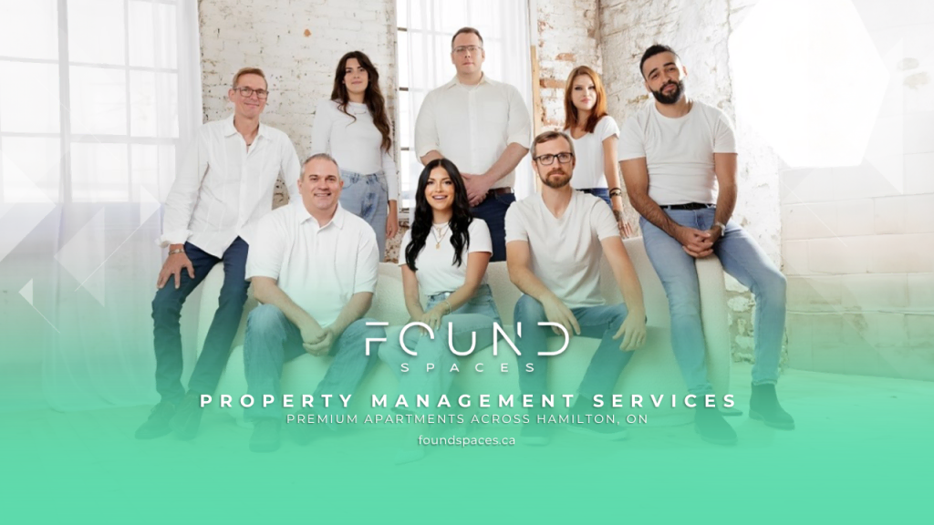 A group of eight people posing indoors in casual attire. The text reads: "Found Spaces - Property Management Services. Premium apartments across Hamilton, ON, and the best property management in Guelph."
