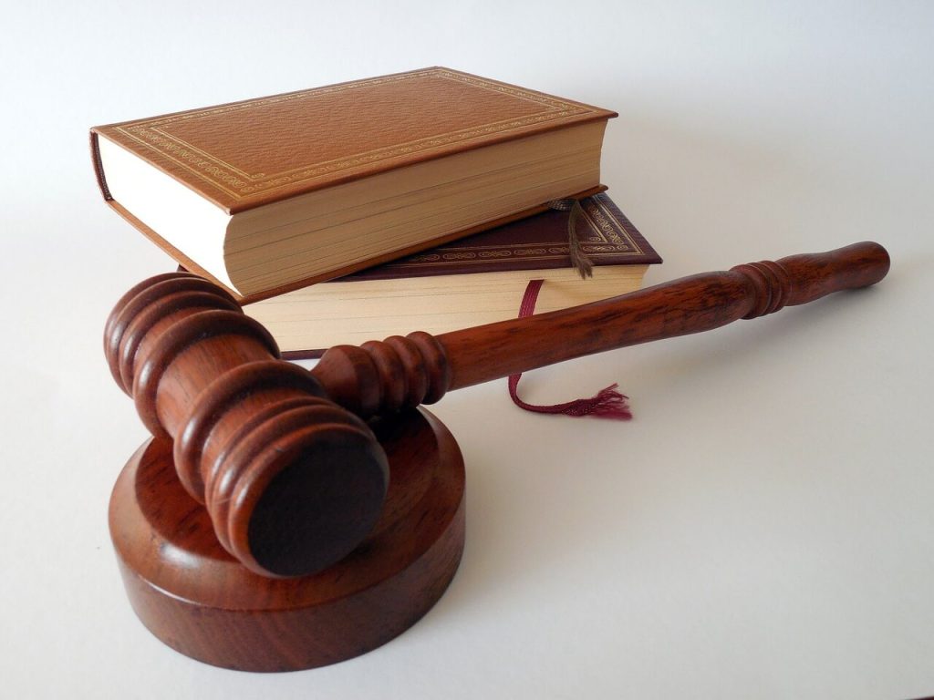 A wooden gavel sits on top of a book, symbolizing the authoritative power in Canadian rental laws.