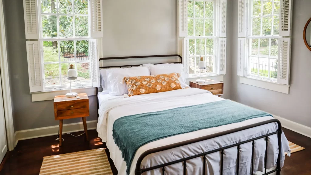 A bedroom with a bed and dresser is available for Airbnb property management.