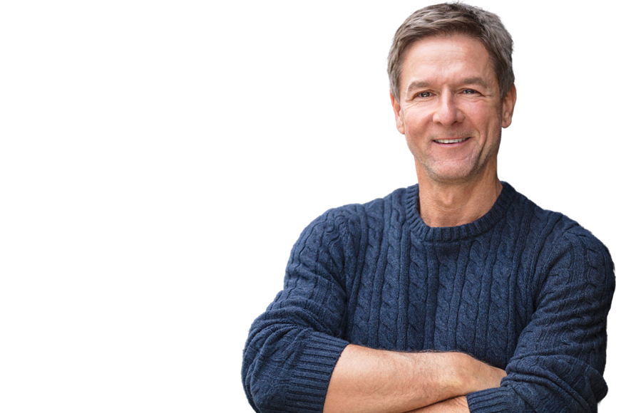 A man in a blue sweater smiling at the camera, arms crossed, with a transparent background.