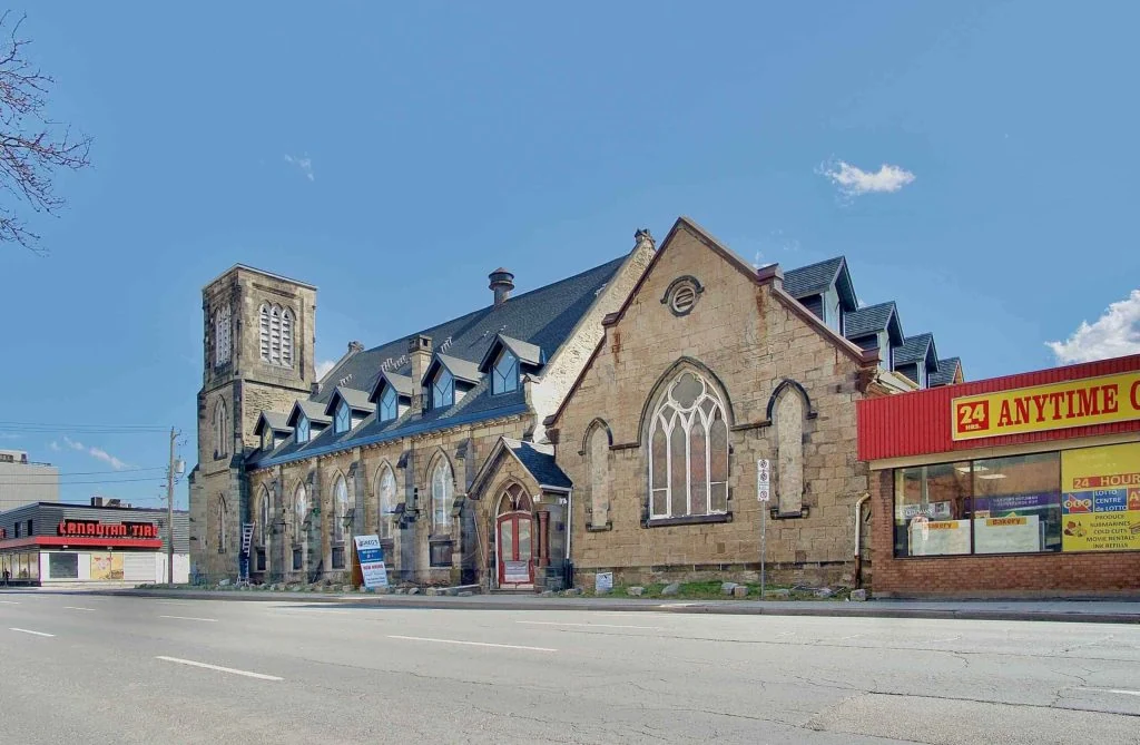 a building with a steeple and a street sign, property management needs in Hamilton