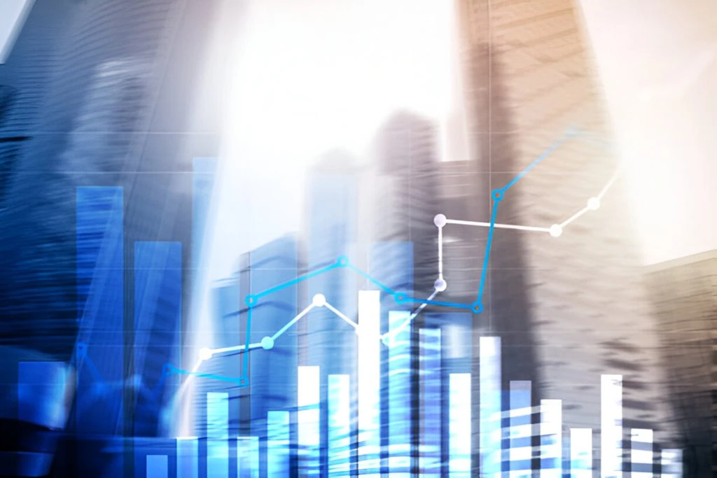 A bar and line graph superimposed on blurred city buildings, representing financial and business data analytics, highlights property management services.