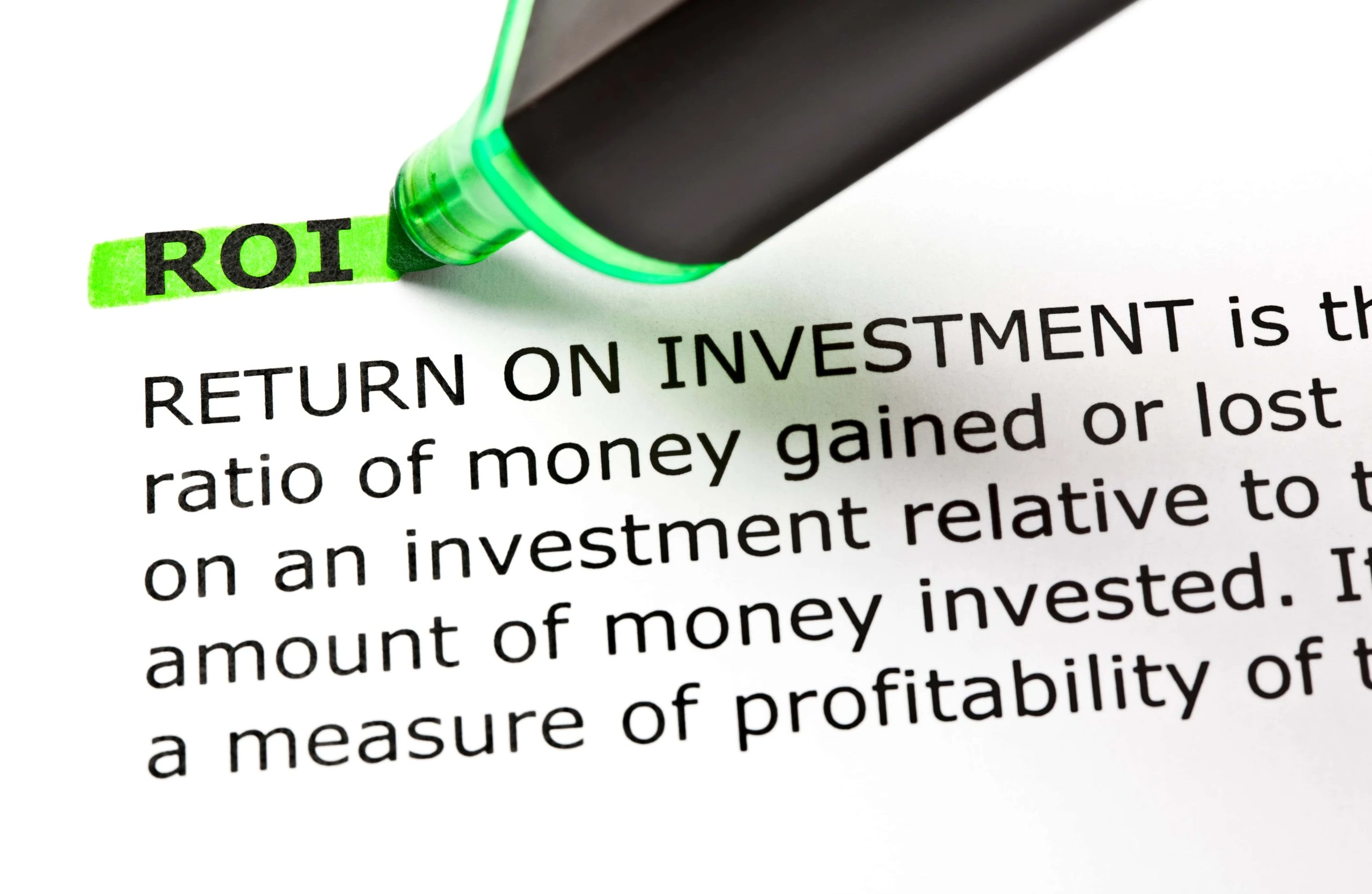 Highlighted text reads "ROI" at the beginning of a document defining Return on Investment, with an investment calculator and a green highlighter visible at the top.