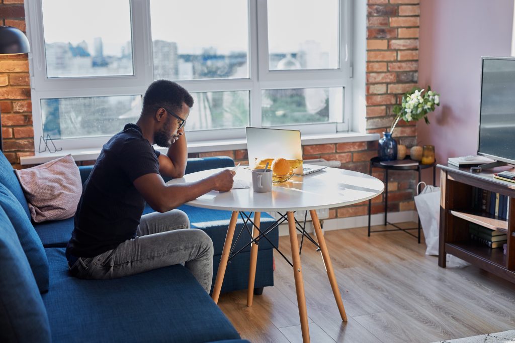 portrait young african man concentrated work home