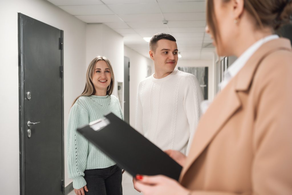 woman in suit talking to couple in new building r 2024 10 31 23 20 51 utc