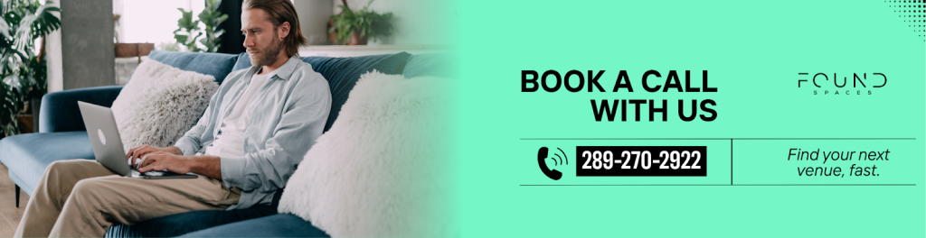 A man sits on a blue couch using a laptop to inspect property options. Text reads: “Book a call with us, 289-270-2922. Found Spaces. Find your next venue, fast.”.