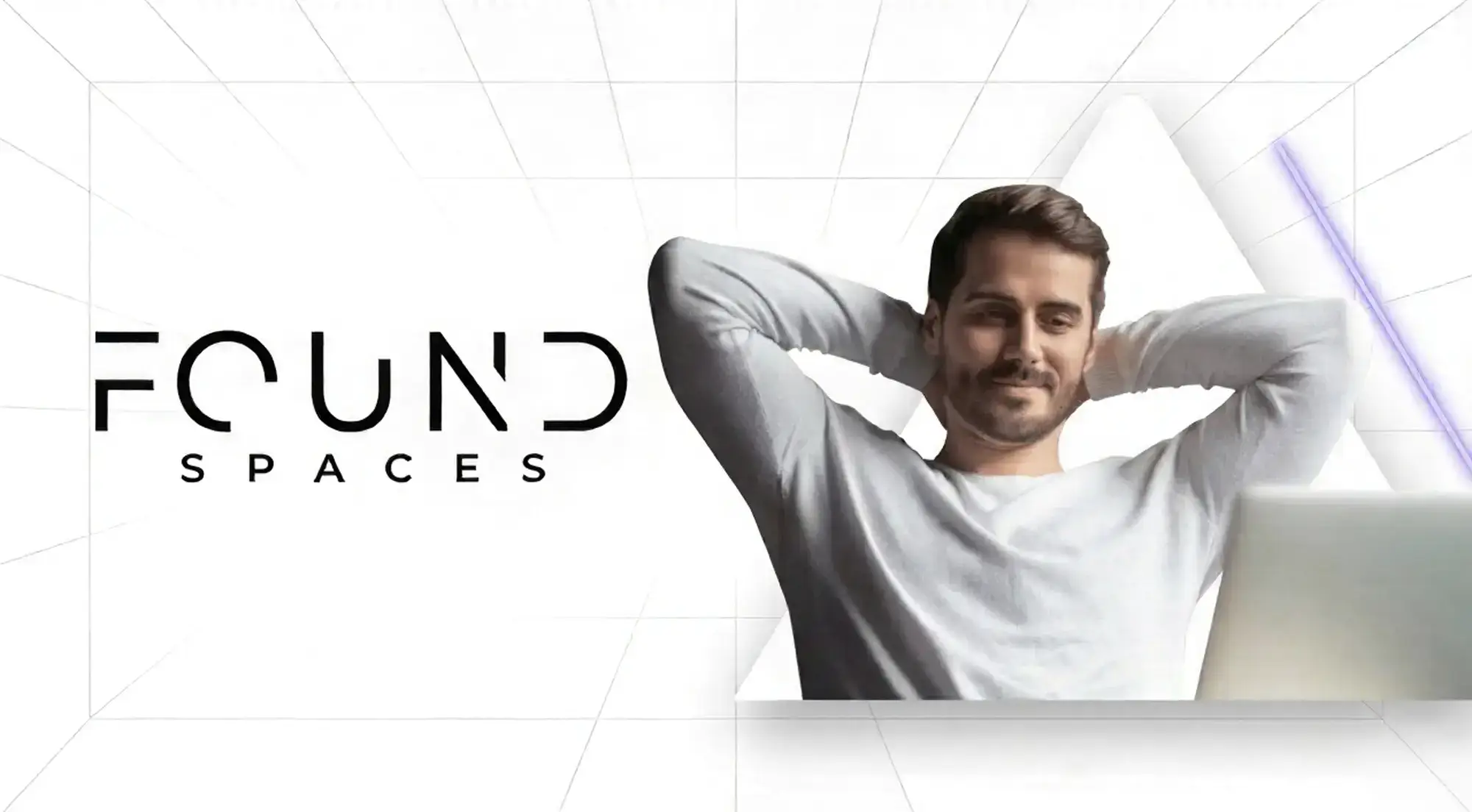 A man with a beard smiles and leans back with his hands behind his head, next to the text "Found Spaces" on a white geometric background.